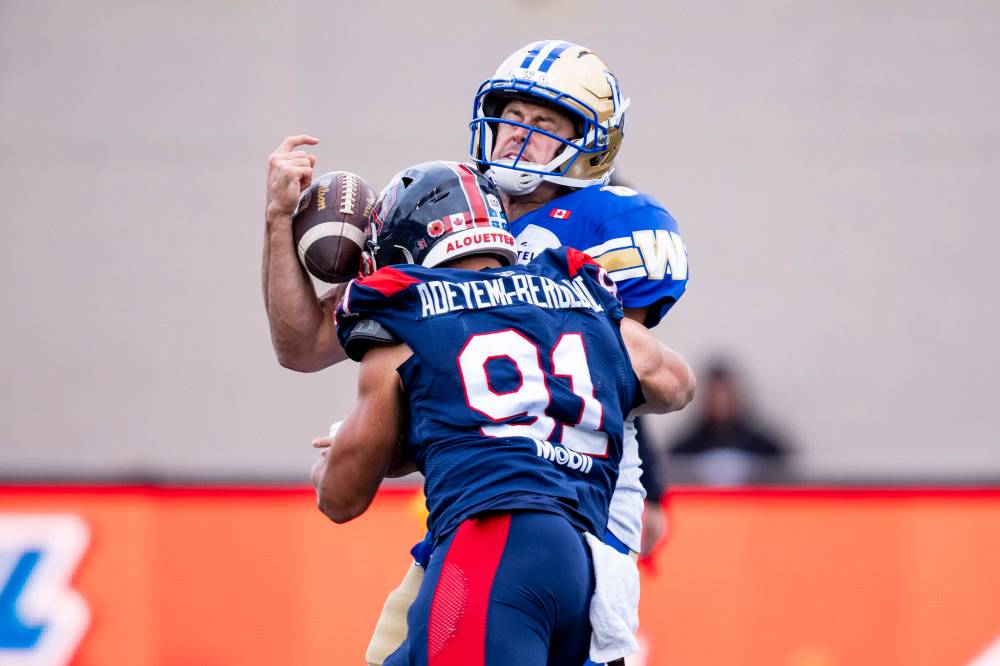 CHRISTOPHER KATSAROV / THE CANADIAN PRESS
Montreal Alouettes’ Isaac Adeyemi-Berglund (91) sacks Winnipeg Blue Bombers quarterback Zach Collaros (8) during first half Eastern semi-final action, in Montreal on Saturday, Nov. 1, 2025.