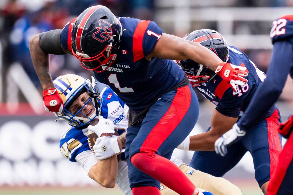 CHRISTOPHER KATSAROV / THE CANADIAN PRESS
Montreal Alouettes’ Darnell Sankey (1) hits Winnipeg Blue Bombers’ Joey Corcoran (81) during first half Eastern semi-final action, in Montreal on Saturday, Nov. 1, 2025.