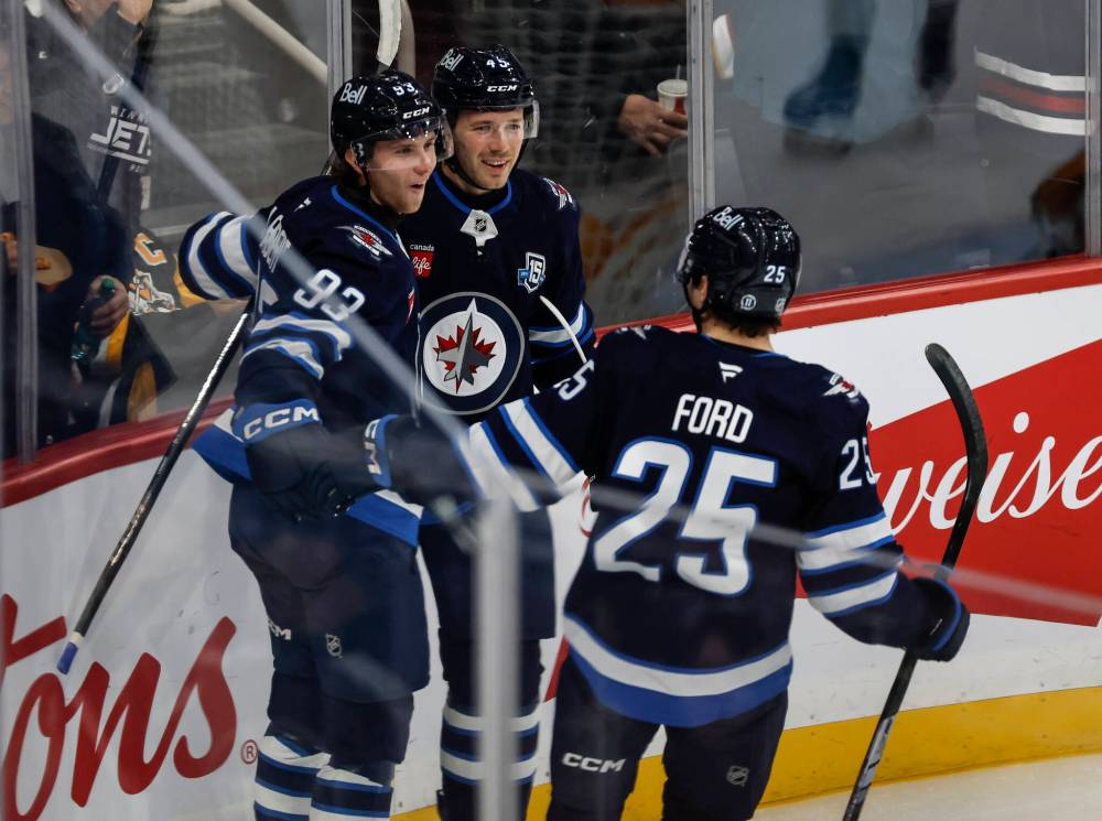 Winnipeg Jets' Brad Lambert (93), Cole Koepke (45) and Parker Ford (25) celebrate Lambert’s goal against the Pittsburgh Penguins during first period NHL action in Winnipeg, Saturday, Nov. 1, 2025. THE CANADIAN PRESS/John Woods