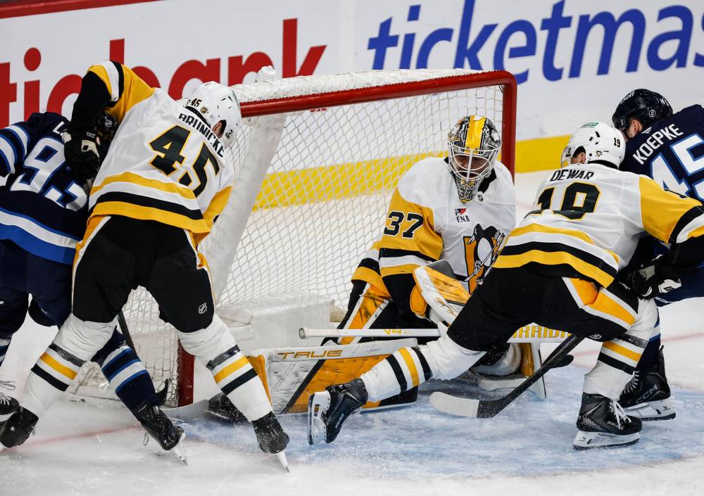 Winnipeg Jets' Brad Lambert (93) scores on Pittsburgh Penguins goaltender Arturs Silovs (37) as Harrison Brunicke (45) and Connor Dewar (19) defend during first period NHL action in Winnipeg, Saturday, Nov. 1, 2025. THE CANADIAN PRESS/John Woods