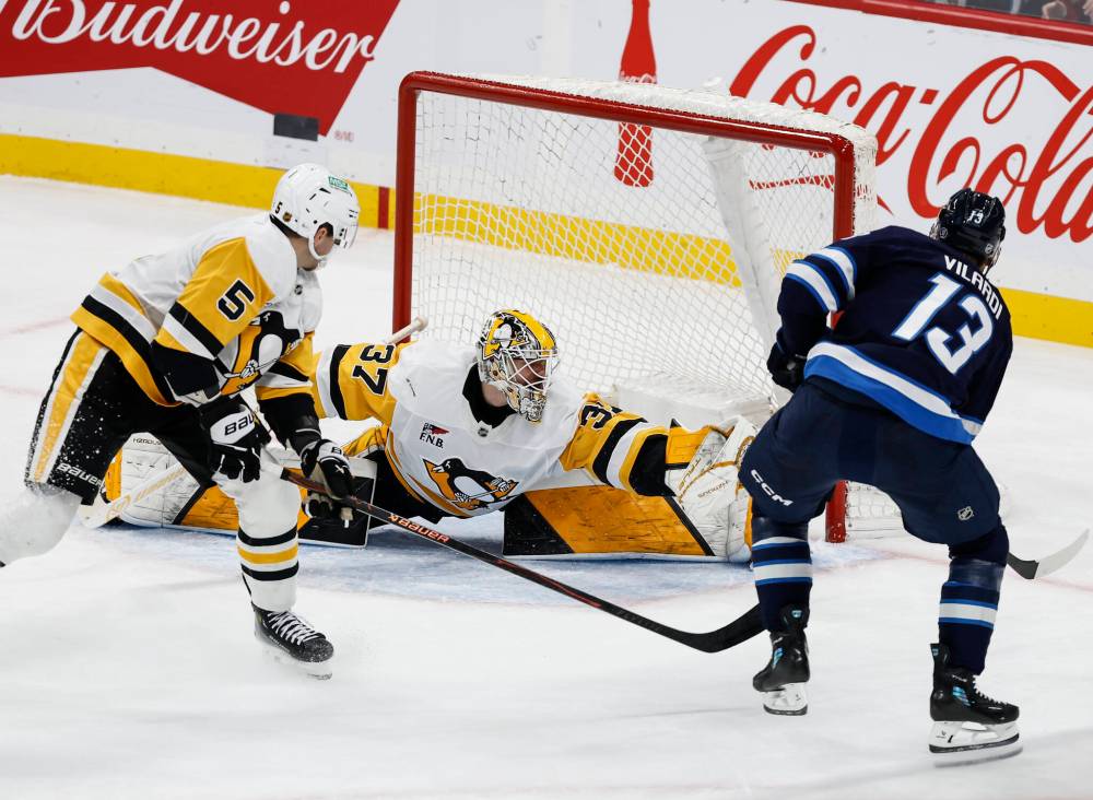 Pittsburgh Penguins goaltender Arturs Silovs (37) saves the shot from Winnipeg Jets' Gabriel Vilardi (13) during second period NHL action in Winnipeg, Saturday, Nov. 1, 2025. THE CANADIAN PRESS/John Woods
