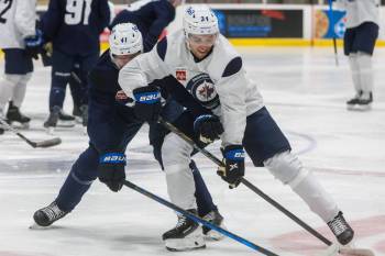 MIKE DEAL / FREE PRESS Files
                                David Gustafsson (41) and Ville Heinola (34) fight for the puck during training camp in September.