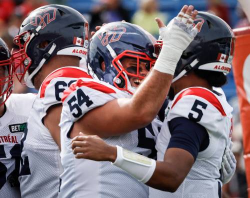 Jeff McIntosh / THE CANADIAN PRESS FILES
                                Montreal Alouettes&rsquo; Justin Lawrence (centre) celebrates a touchdown.