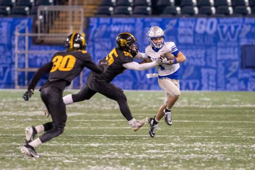 BROOK JONES/FREE PRESS
                                Oak Park Raiders receiver, and ANAVETS Bowl MVP, Tavin Parani (right) carries the ball Thursday night with Dakota Lancers defender Luke Edmondson in hot pursuit.