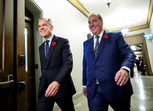 Prime Minister Mark Carney walks with MP Chris d’Entremont, who crossed the floor from Conservative caucus to join the Liberals last week. It’s possible we’ll see resignations from Conservatives who want to abandon ship, Dan Lett writes.
                                (The Canadian Press files)