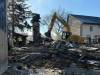 SCOTT BILLECK / FREE PRESS
                                A vacant house on the 500 block of William Avenue is demolished Thursday after a fire that started late Wednesday.