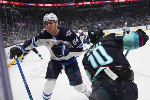 Lindsey Wasson / The Associated Press
                                Winnipeg Jets defenceman Logan Stanley prepares to collide with Seattle Kraken centre Matty Beniers during the first period, Thursday.