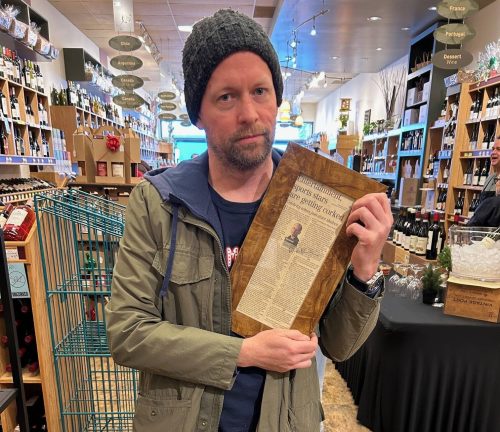 Supplied
                                Ben Sigurdson holds a framed copy of his first Uncorked column at Kenaston Wine Market.