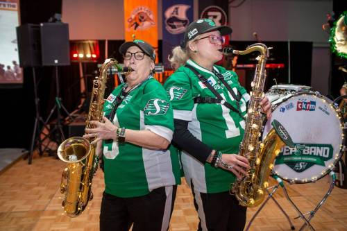 BROOK JONES/FREE PRESS 620 CKRM Saskatchewan Roughrider Pep Band members Betsy Macpherson , 69, (left) who is from Regina, Sask., and Kim Bircher, 54, who is from Montmartre, Sask., are pictured inside the Team Party Room - Eastern Social Hall at the Grey Cup Festival Hub at the RBC Convention Centre in Winnipeg, Man., Thursday, Nov. 13, 2025.