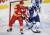 Winnipeg Jets' Dylan Samberg (54) shoves Calgary Flames' Jonathan Huberdeau (10) away from the net during first period NHL hockey action in Calgary, Alta., Saturday, Nov. 15, 2025. THE CANADIAN PRESS/Jeff McIntosh