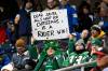 A Saskatchewan Roughriders fan holds a poster board sign prior to first half CFL football action between the Montreal Alouettes and Saskatchewan Roughriders at the 112th Grey Cup, in Winnipeg on Sunday, Nov. 16, 2025. (Fred Greenslade / The Canadian Press)