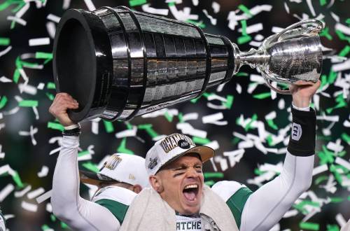 Saskatchewan Roughriders quarterback Trevor Harris hoists the Grey Cup after Saskatchewan defeated the Montreal Alouettes during the 112th CFL Grey Cup, in Winnipeg, on Sunday, November 16, 2025. THE CANADIAN PRESS/Darryl Dyck
