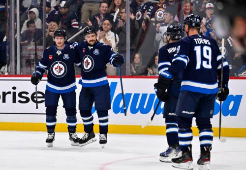 Fred Greenslade / THE CANADIAN PRESS
                                Winnipeg Jets defenceman Neal Pionk (second left) celebrates his power-play goal against the Columbus Blue Jackets Tuesday with his teammates.