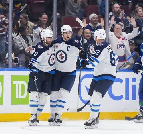 Darryl Dyck / THE CANADIAN PRESS
                                Adam Lowry (centre) celebrates a Jets goal against the Vancouver Canucks with Alex Iafallo (left) and Nino Niederreiter. ‘I picture myself as a Winnipeg Jet for life,’ the team’s captain said last spring.