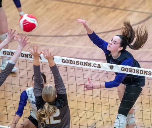 BROOK JONES / FREE PRESS FILES
                                Vincent Massey (Brandon) Vikings left side Hannah McGregor (right) spikes the volleyball in last year’s semifinals game against the Steinbach Sabres.
