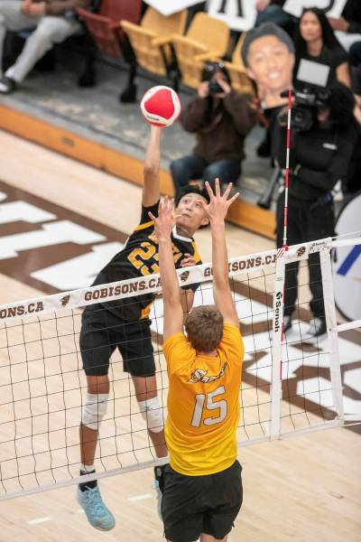 BROOK JONES / FREE PRESS
                                Dakota Lancers&rsquo; Jordan Bagnas spikes the ball while the Steinbach Sabres&rsquo; Joseph LeClair (No. 15) goes for the block Thursday night.