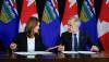 The Canadian Press
                                Prime Minister Mark Carney, right, signs an MOU with Alberta Premier Danielle Smith in Calgary, Alta. on Thursday.