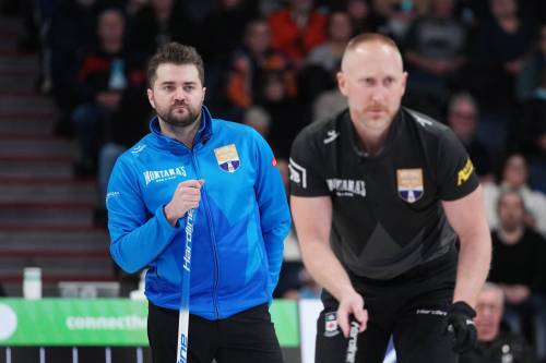 Darren Calabrese / THE CANADIAN PRESS
                                Matt Dunstone (left) looks over the shoulder of Brad Jacobs as he plots strategy Friday night in Halifax.