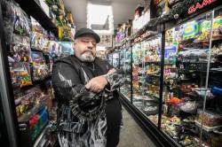 MIKAELA MACKENZIE / FREE PRESS Michael Paille, owner of Cobra Collectibles and executive director at Sargent Business Community, in his store on Friday, Nov. 28, 2025. He’s had to lock up most of his merchandise in glass cases to fight crime. For Malak story. Free Press 2025