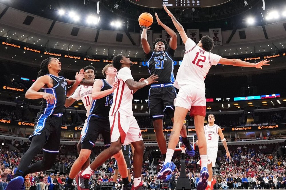 Duke center Patrick Ngongba (21) shoots against Arkansas forward Malique Ewin (12) during the first half of an NCAA college basketball game in the CBS Sports Thanksgiving Classic tournament Thursday, Nov. 27, 2025, in Chicago. (AP Photo/Nam Y. Huh)