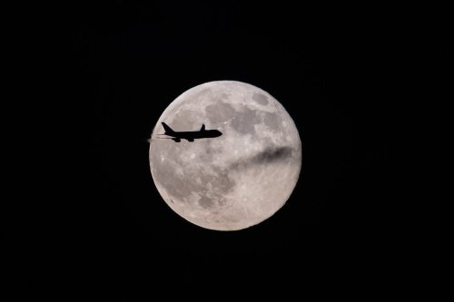 A UPS Boeing 747 inbound from Anchorage, Alaska, passes in front of the supermoon as it approaches Louisville Muhammad Ali International Airport on Wednesday, Nov. 5, 2025, in Louisville, Ky. (AP Photo/Jon Cherry)