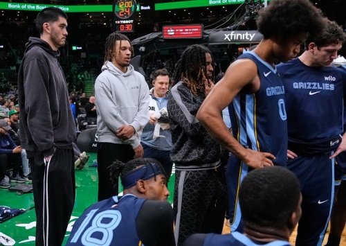Memphis Grizzlies guard Ja Morant, second from left, who is sidelined with an injury, watches the team gather during the end of the first quarter of an NBA basketball game against the Boston Celtics, Wednesday, Nov. 12, 2025, in Boston. (AP Photo/Charles Krupa)