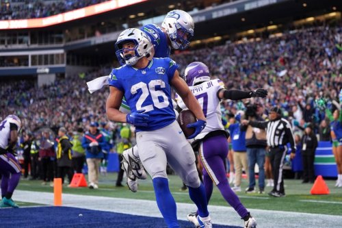 Seattle Seahawks running back Zach Charbonnet (26) celebrates with tight end Nick Kallerup (89) after scoring a touchdown against the Minnesota Vikings during the second half of an NFL football game Sunday, Nov. 30, 2025, in Seattle. (AP Photo/Lindsey Wasson)