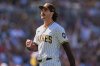 FILE - San Diego Padres starting pitcher Dylan Cease celebrates after the third out during the third inning of a baseball game against the Milwaukee Brewers, Sept. 24, 2025, in San Diego. (AP Photo/Gregory Bull, File)
