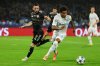Napoli's David Neres, right, and Qarabag's Marko Jankovic, left, in action during the Champions League opening phase soccer match between Napoli and Qarabag in Naples, Italy, Tuesday Nov. 25, 2025. (Alessandro Garofalo/LaPresse via AP)