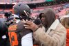 Cleveland Browns quarterback Shedeur Sanders (12) visits with his father Deion Sanders, right, during warmups before an NFL football game against the Tennessee Titans in Cleveland, Sunday, Dec. 7, 2025. (AP Photo/Sue Ogrocki)