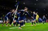 Scotland's Scott McTominay celebrates with teammates after Kenny McLean scored their fourth goal in the 2026 World Cup European Qualifying soccer match between Scotland and Denmark at Hampden Park, Glasgow, Scotland, Tuesday, Nov. 18, 2025. (Andrew Milligan/PA via AP)