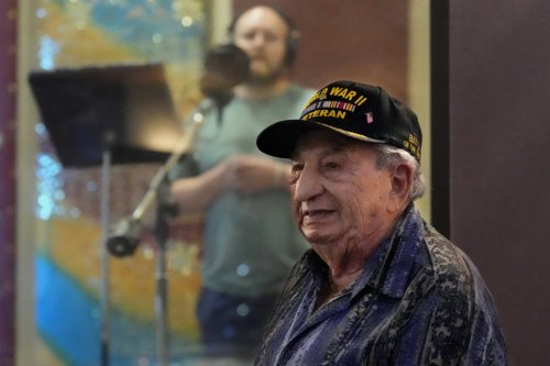 Irving Locker, a 101-year-old veteran of World War II, D-Day and the Battle of the Bulge, listens as Jesse Wayne Taylor, left, records a song based on Locker's military experience on Wednesday, Sept. 9, 2025, in Nashville, Tenn. (AP Photo/Mark Humphrey)