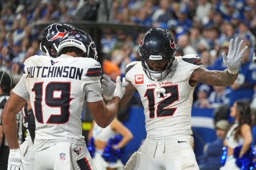 Houston Texans' Nico Collins (12) celebrates with Xavier Hutchinson (19) after scoring a touchdown against the Indianapolis Colts during the second half of an NFL football game Sunday, Nov. 30, 2025, in Indianapolis. (AP Photo/Michael Conroy)