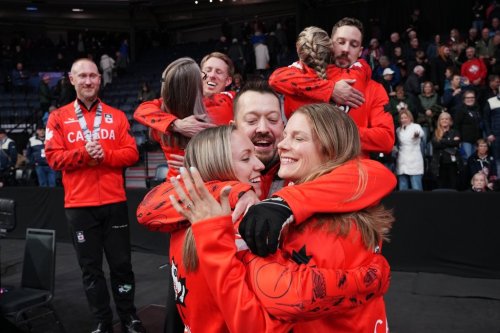 Ben Hebert hugs Rachel Homan, left, and Sarah Wilkes after the three were victorious at the Montana's Canadian Curling Trials in Halifax on Nov. 29, 2025. THE CANADIAN PRESS/Darren Calabrese