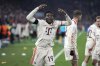 Bayern's Alphonso Davies, centre, celebrates after scoring his side's opening goal during the Champions League playoff second leg soccer match between FC Bayern Munich and Celtic Glasgow at the Allianz Arena in Munich, Germany, Tuesday, Feb. 18, 2025. (AP Photo/Matthias Schrader)