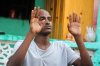 Mohamed Abdi Awale, who says he was captured and tortured by smugglers while attempting to reach Europe, gestures during an interview with The Associated Press in Mogadishu, Somalia, Monday, Nov. 17, 2025. (AP Photo/Farah Abdi Warsameh)
