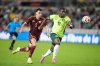 Australia's Al Hassan Toure (11) and Venezuela's Teo Quintero Leon (5) chase the ball during the second half of an international friendly soccer match, Friday, Nov. 14, 2025, in Houston. (AP Photo/Karen Warren)