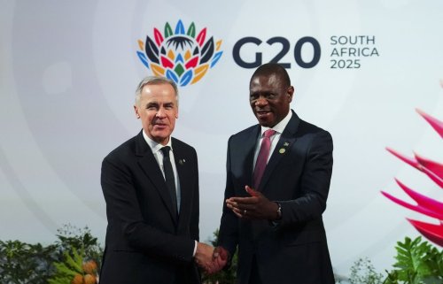 Prime Minister Mark Carney is welcomed by Paul Mashatile, Deputy President of South Africa, as he arrives to the G20 in Johannesburg, South Africa, on Saturday, Nov. 22, 2025. THE CANADIAN PRESS/Sean Kilpatrick