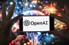 The OpenAI logo is seen displayed on a cell phone in front of an image on a computer screen generated by ChatGPT's Dall-E text-to-image model, Friday, Dec. 8, 2023, in Boston. Videos from the Sora 2 text-to-video app, developed by OpenAI, and other artificial intelligence models claiming to show real events are racking up millions of views online. THE CANADIAN PRESS/AP-Michael Dwyer