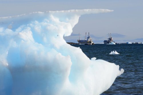 Ships are framed by pieces of melting sea ice in Frobisher Bay in Iqaluit, Nvt., on Wednesday, July 31, 2019. THE CANADIAN PRESS/Sean Kilpatrick