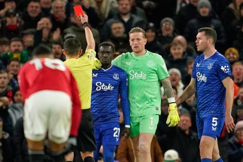 Everton's Idrissa Gueye, third right, gets a red card from referee Tony Harrington during the English Premier League soccer match between Manchester United and Everton in Manchester, England, Monday, Nov. 24, 2025. (AP Photo/Dave Thompson)