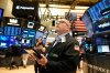 Jeffrey Vazquez works on the floor at the New York Stock Exchange in New York, Thursday, Nov. 13, 2025. (AP Photo/Seth Wenig)