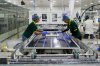 FILE - Workers put switches and connectors on solar panels after they come out of automated framing at a ReNew solar panel manufacturing plant on the outskirts of Jaipur, India, Aug. 21, 2025. (AP Photo/Manish Swarup, File)