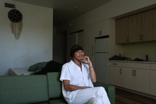 Quantavia Smith sits for a photo in her studio apartment at the Santa Monica and Vermont Apartments in Los Angeles, Monday, Nov. 10, 2025. (AP Photo/Jae C. Hong)