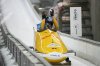 Laura Nolte and Deborah Levi, of Germany, celebrate when finishing their second run during the 2-woman bobsleigh World Cup and Olympic test event in Cortina D'Ampezzo, Italy, Sunday, Nov. 23, 2025. (AP Photo/Andrew Medichini)