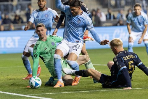 New York City FC goalkeeper Matt Freese, center left, stops a shot on goal by Philadelphia Union defender Jakob Glesnes (5) during the first half of MLS soccer's Eastern Conference semifinal, Sunday, Nov. 23, 2025, in Chester, Pa. (AP Photo/Laurence Kesterson)