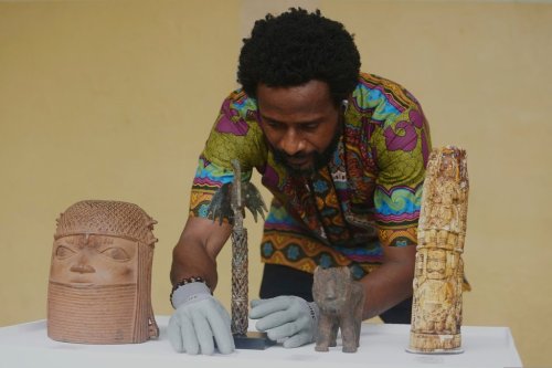 FILE - Benin bronzes looted in the past and returned to Nigeria are examined during a handing over ceremony in Lagos Nigeria, Saturday June 21, 2025. (AP Photo/Sunday Alamba, file)