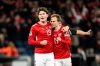 Denmark's Jonas Wind and Mikkel Damsgaard, right, celebrate during a World Cup qualifying soccer match against Belarus in Copenhagen, Denmark, Saturday, Nov. 15, 2025. (Ida Marie Odgaard/Ritzau Scanpix via AP)