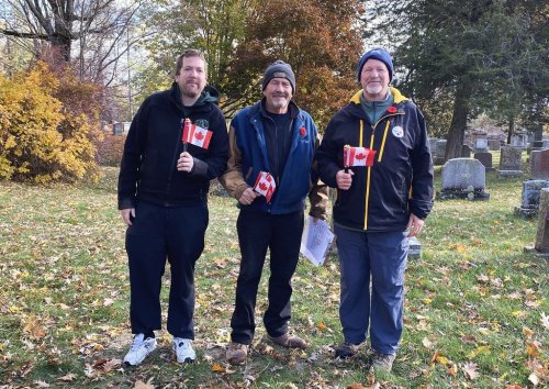 Robert Gibson, left to right, Bill Anderson and Glenn Holland pose for a photo while volunteering for a group placing Canadian flags on the graves of the fallen soldiers at Cataraqui Cemetery in Kingston, Ont., on Thursday, Nov. 8, 2025. THE CANADIAN PRESS/Sharif Hassan