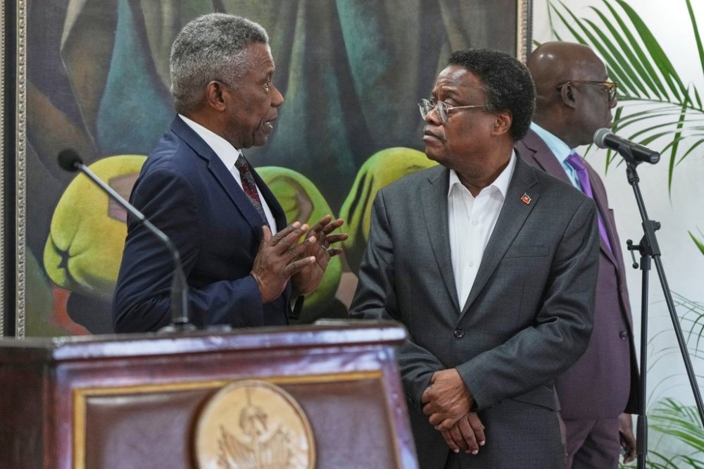 Chief of Protocol of the National Palace Marc Marie Yves Mazile speaks to Fritz Alphonse Jean, a member of Haitiu2019s transitional presidential council, before the start of a press conference in Port-au-Prince, Haiti, Tuesday, Nov. 25, 2025. (AP Photo/Odelyn Joseph)